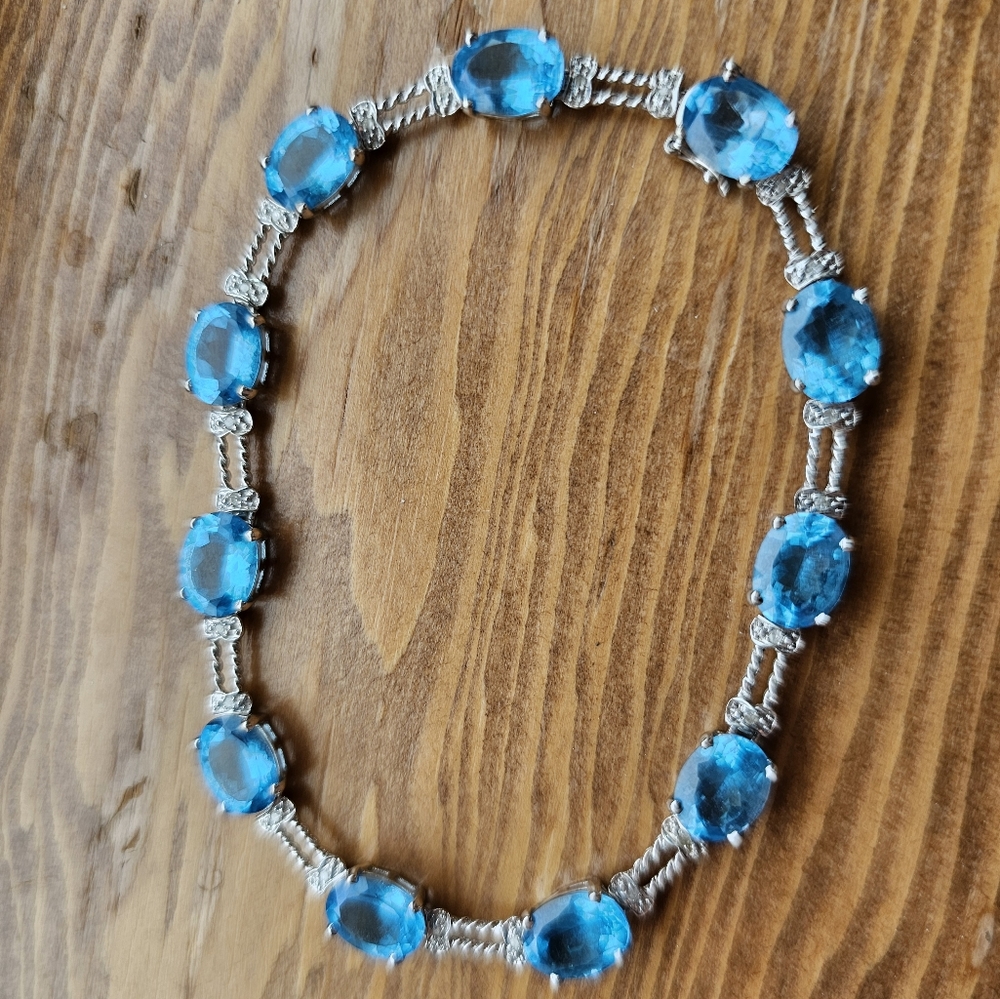 10k blue topaz & diamond bracelet. Stamped 10k. White gold. Please note: one tin